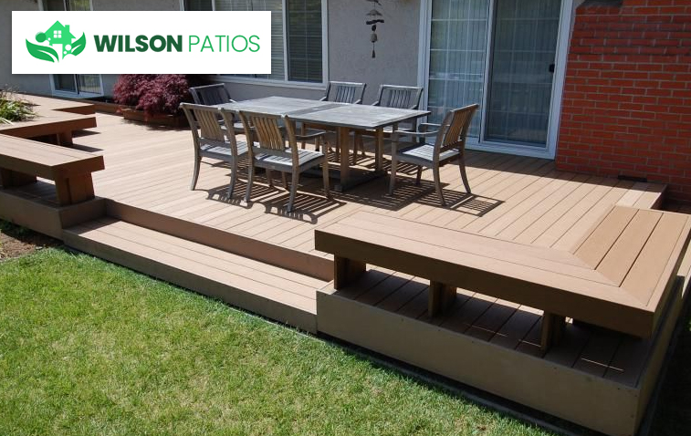 Raised patio with outdoor seating on a sloped yard